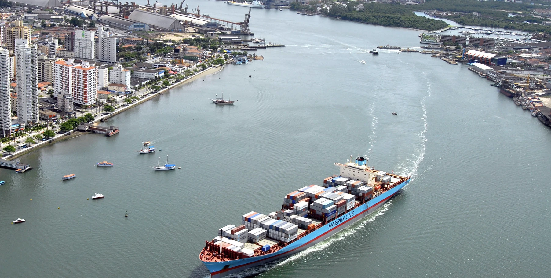 Container ship navigating the access channel at the Port of Santos, Brazil.